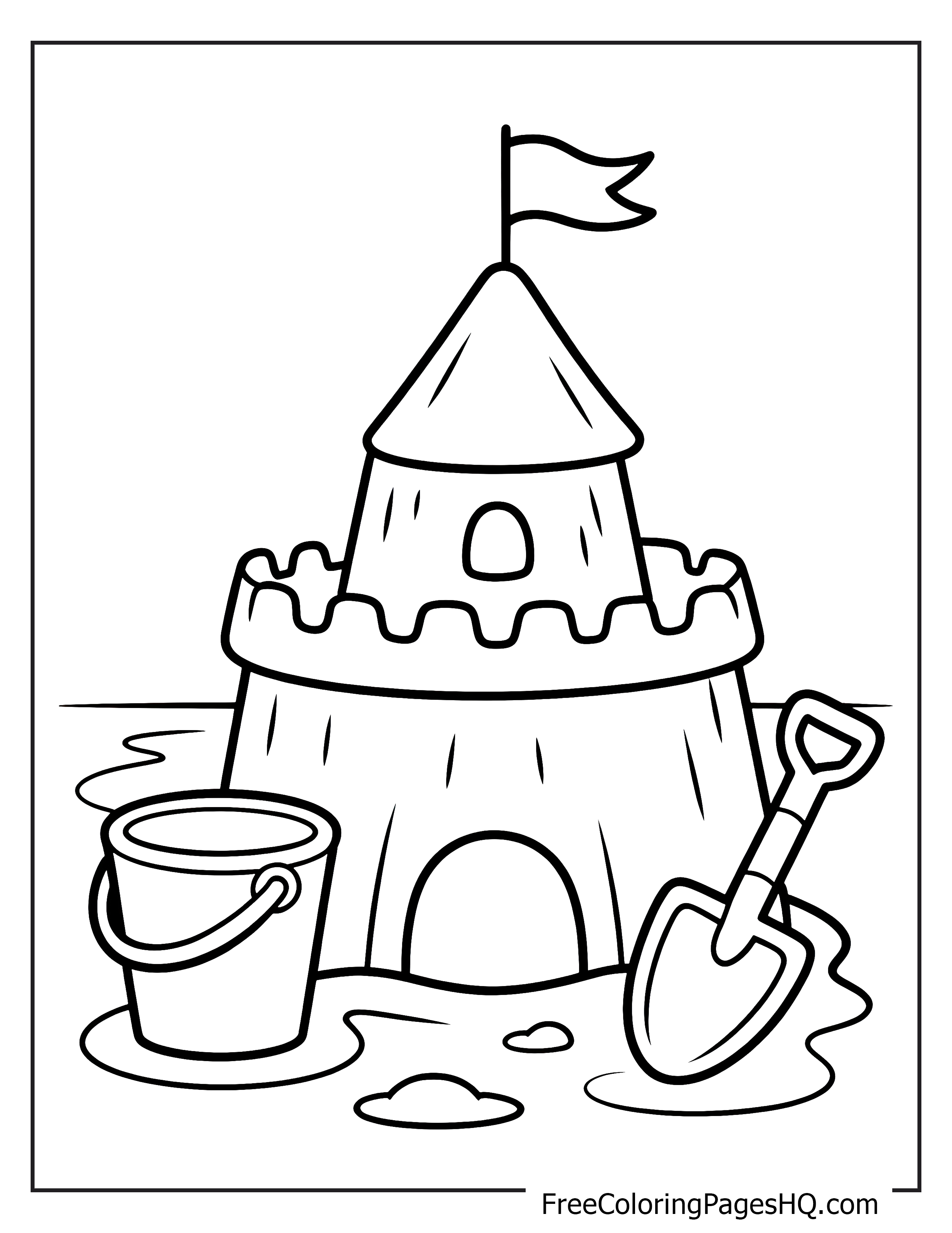 A tall sandcastle with a flag, next to a shovel and pail on the beach.