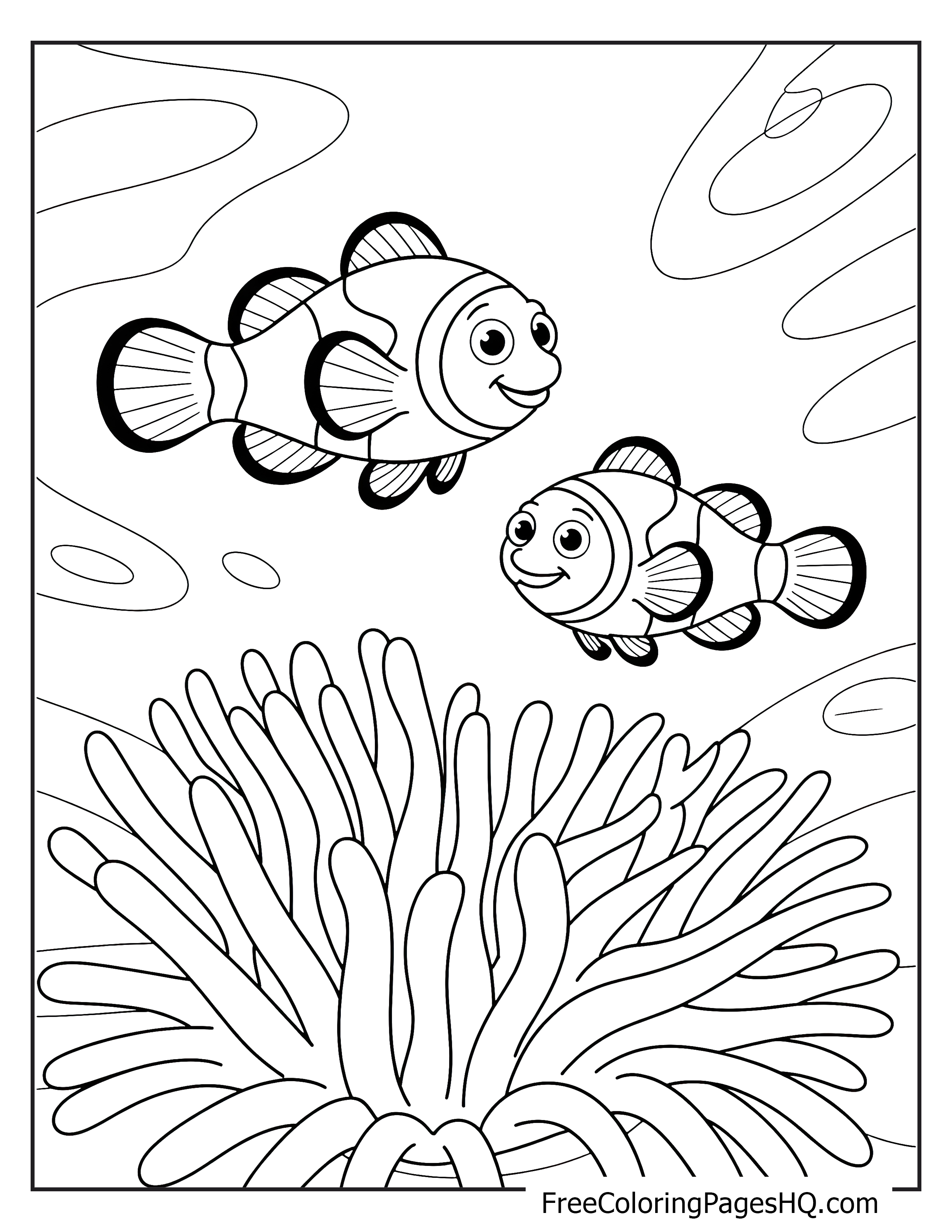 Clownfish swimming around a sea anemone in the ocean.