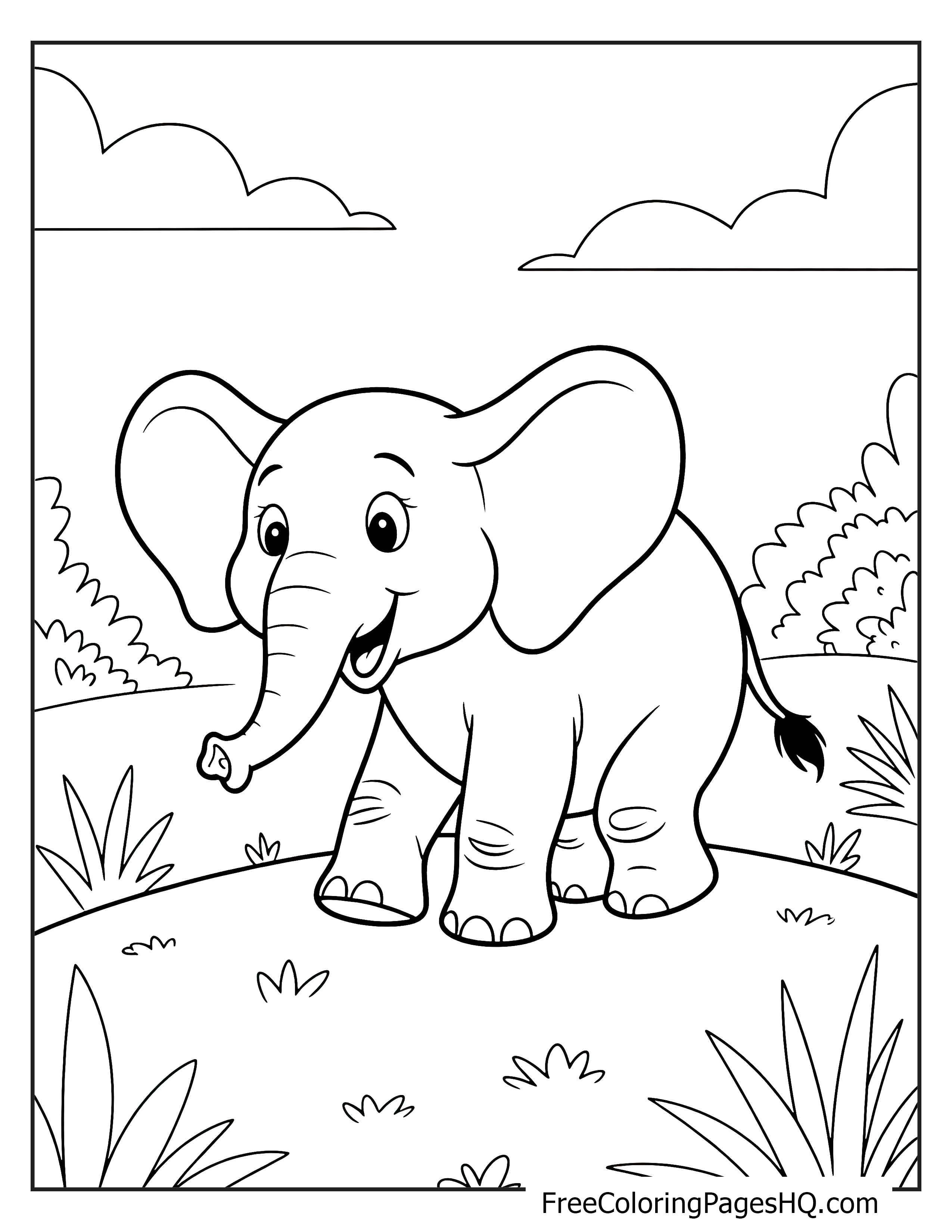 A smiling elephant walks in a grassy meadow with bushes in the background.