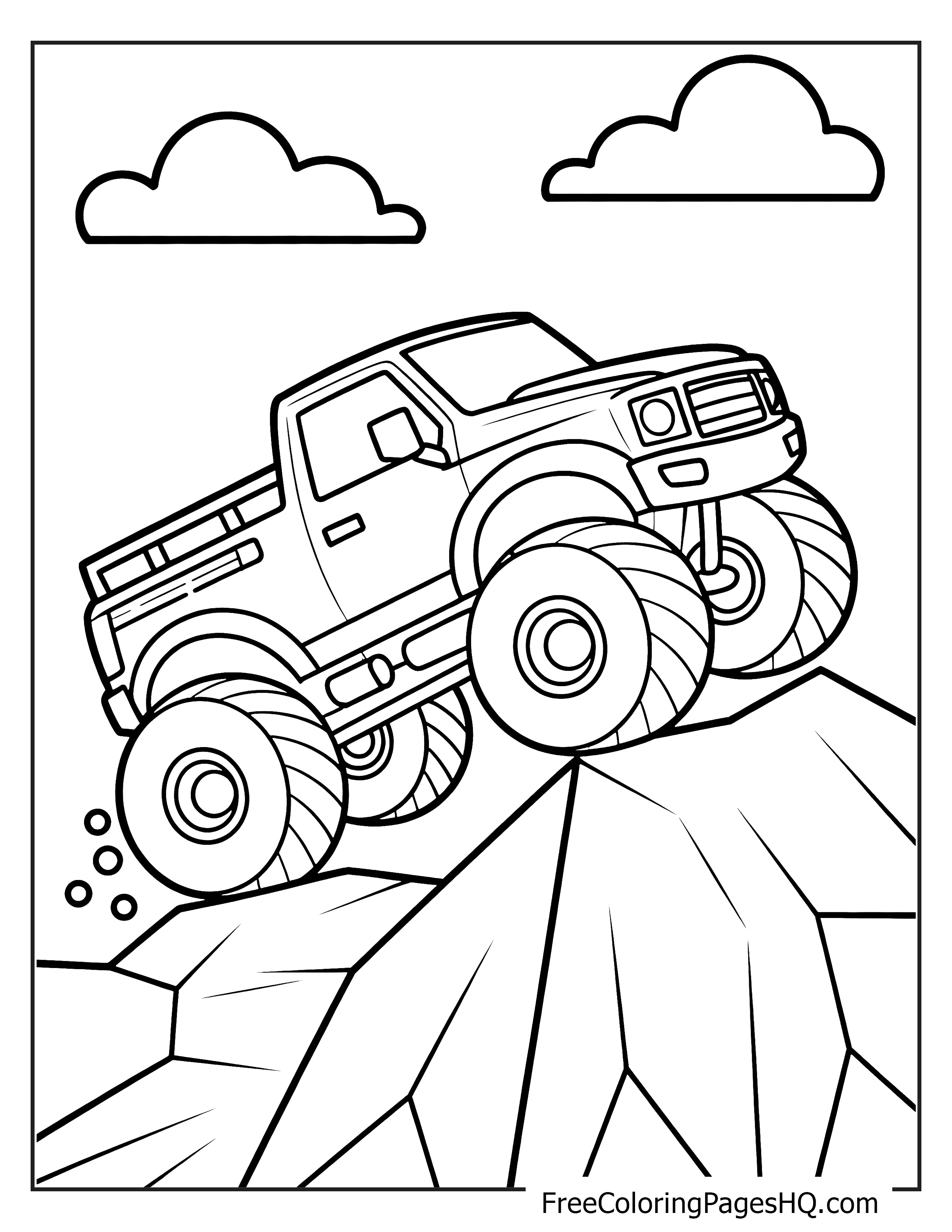 Monster truck driving over rocks with clouds in the background.